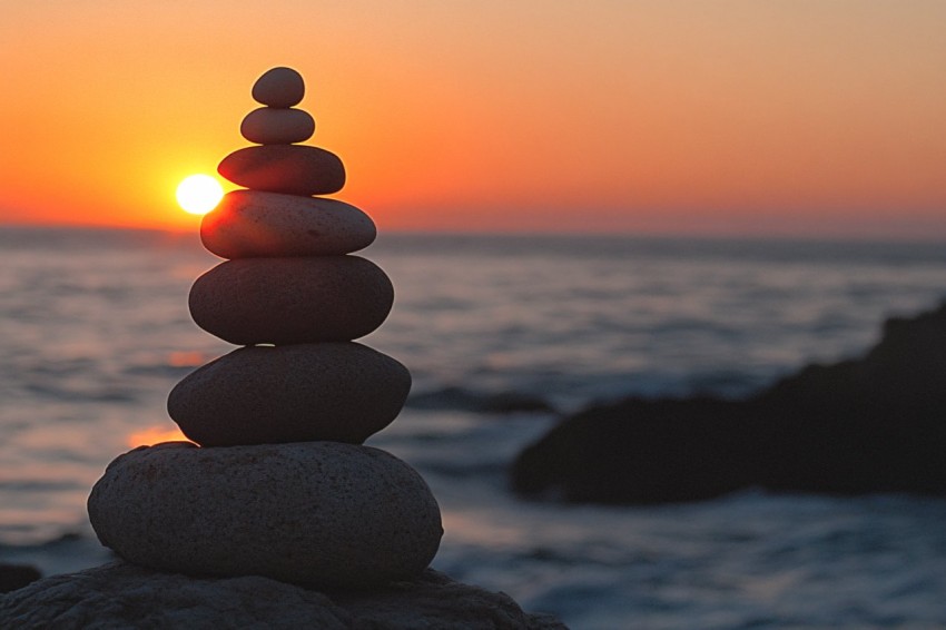 Smooth Stones Balanced at Sunset by the Ocean