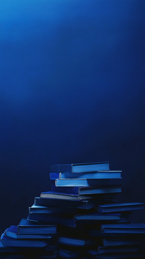 Stack of Books Against Dark Blue Backdrop